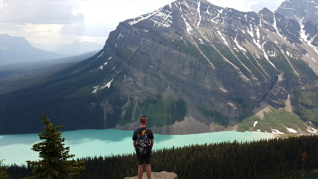 Standing before some sensational scenery a-top of the Little Beehive, looking down on Lake Louise.